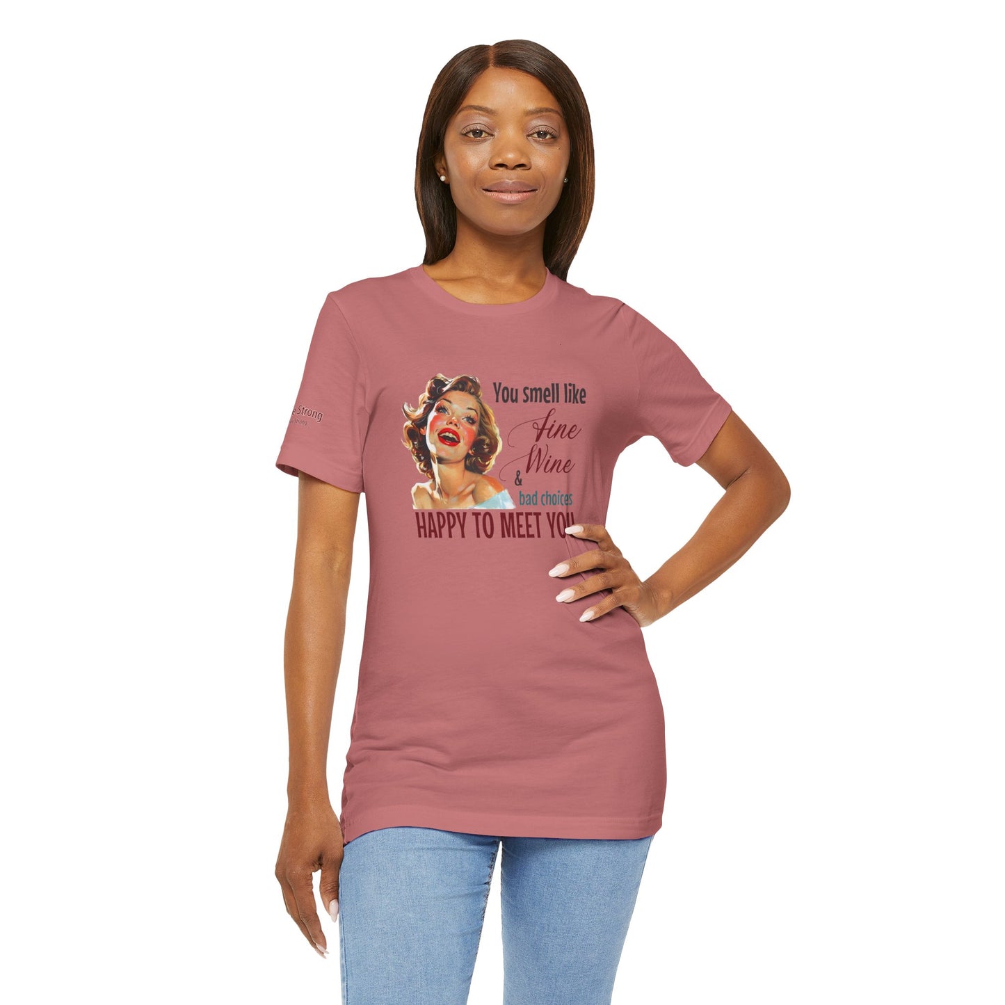 A cheerful, rosy-cheeked pin-up girl with wavy blonde hair smiles brightly. The design features playful retro lettering with the phrase "You smell like fine wine & bad choices – happy to meet you!" in bold, vintage script.