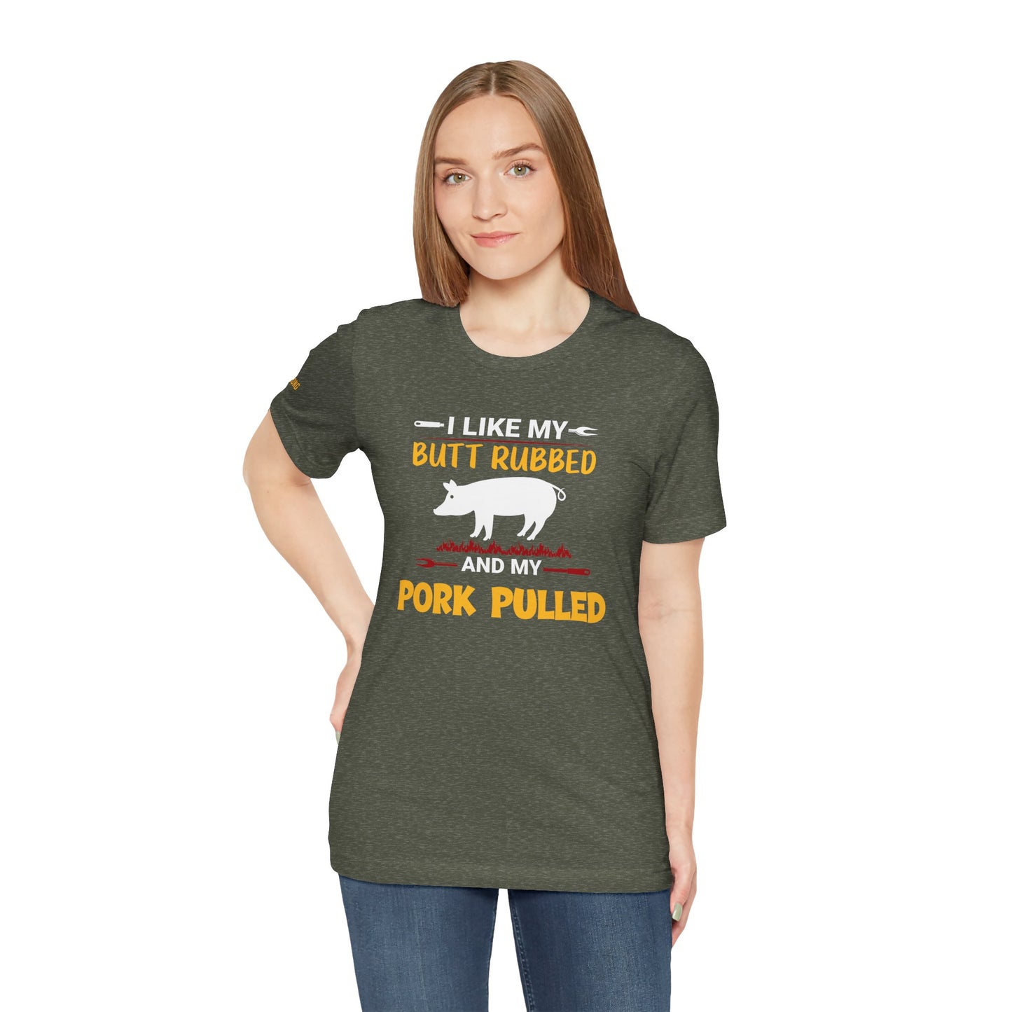 BBQ-themed t-shirt design featuring the phrase "I Like My Butt Rubbed & My Pork Pulled" with a pig silhouette, grill forks, and fire accents.