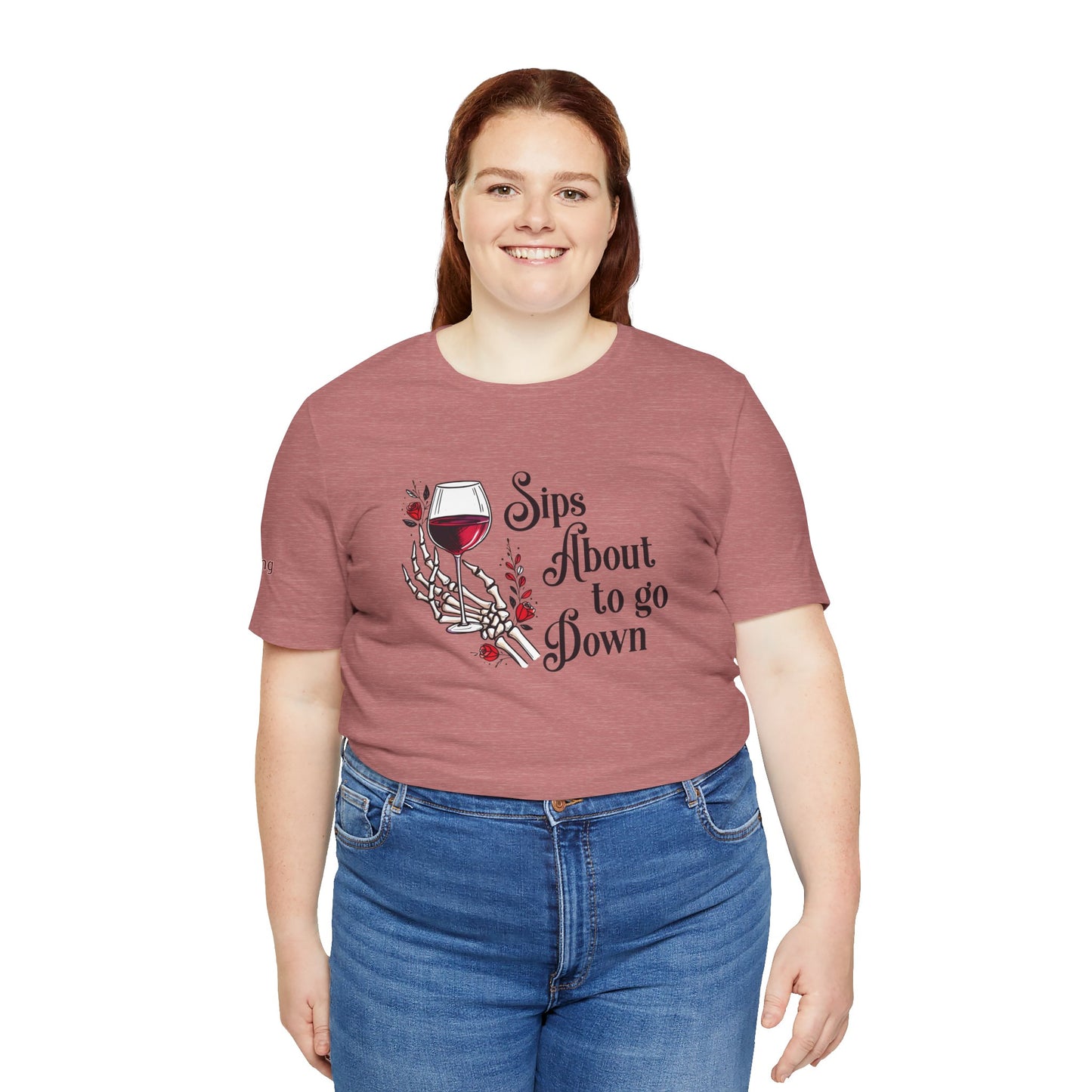A skeleton hand holding a glass of red wine, surrounded by red roses and gothic floral accents, with the text "Sips About to Go Down" in an elegant but eerie font in plus sizes.