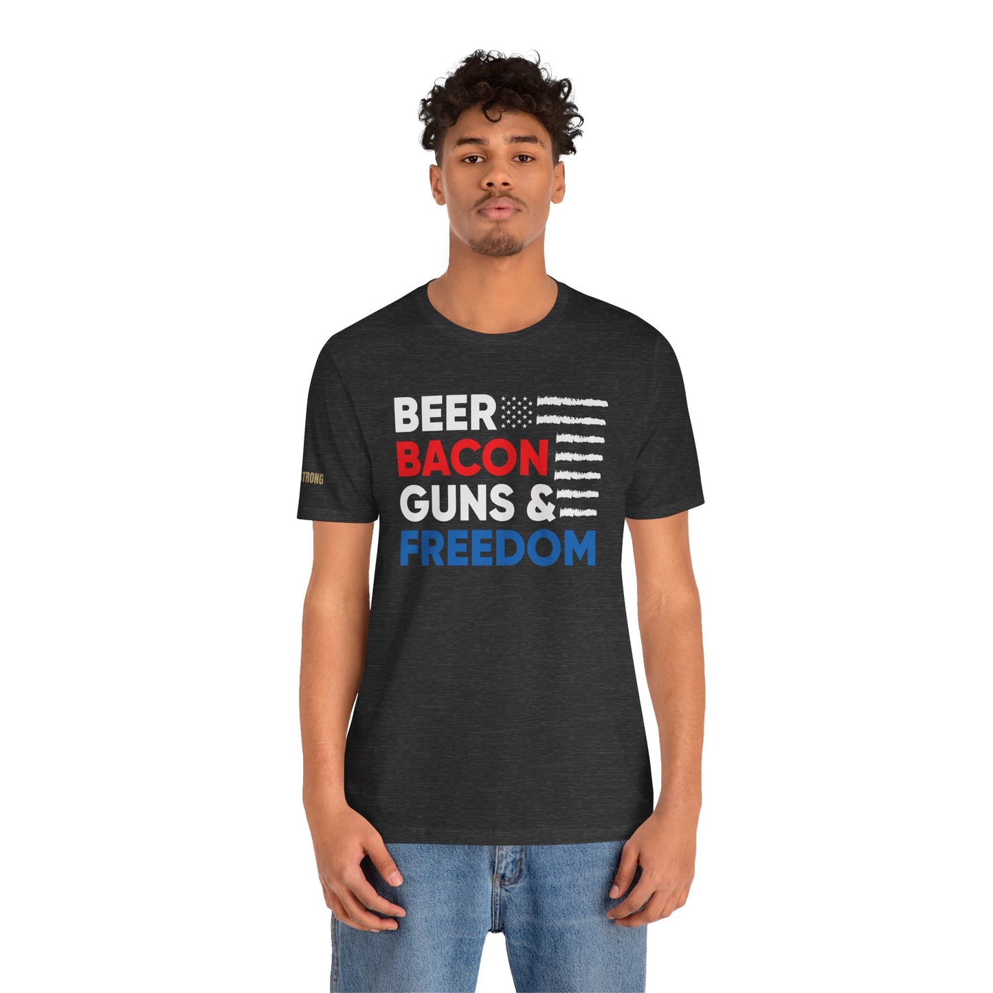Funny quote Beer Bacon Guns & Freedom T-Shirt with bold red, white & blue American flag design – perfect for patriots and beer lovers. In dark heather grey.