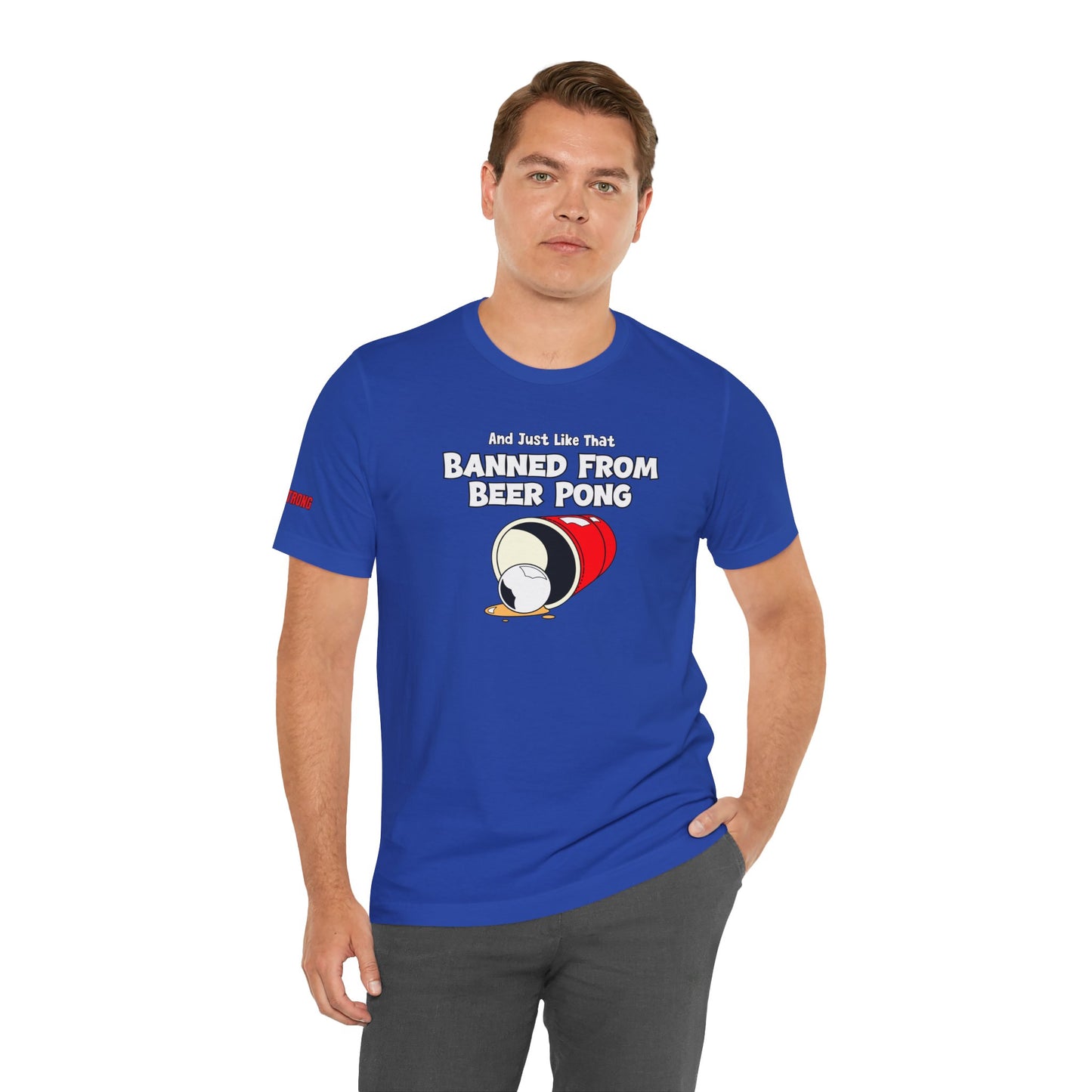 Funny beer pong t-shirt featuring a spilled red party cup and beer pong ball. The text reads “And Just Like That, Banned from Beer Pong” in a bold, playful font.