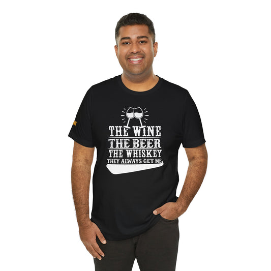 A model wearing "The Wine, The Beer, The Whiskey – They Always Get Me" t-shirt, available in multiple colors and plus sizes, perfect for drink lovers.