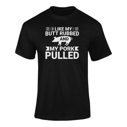 BBQ-themed t-shirt design with the phrase "I Like My Butt Rubbed & My Pork Pulled" featuring a pig silhouette and grilling utensils.