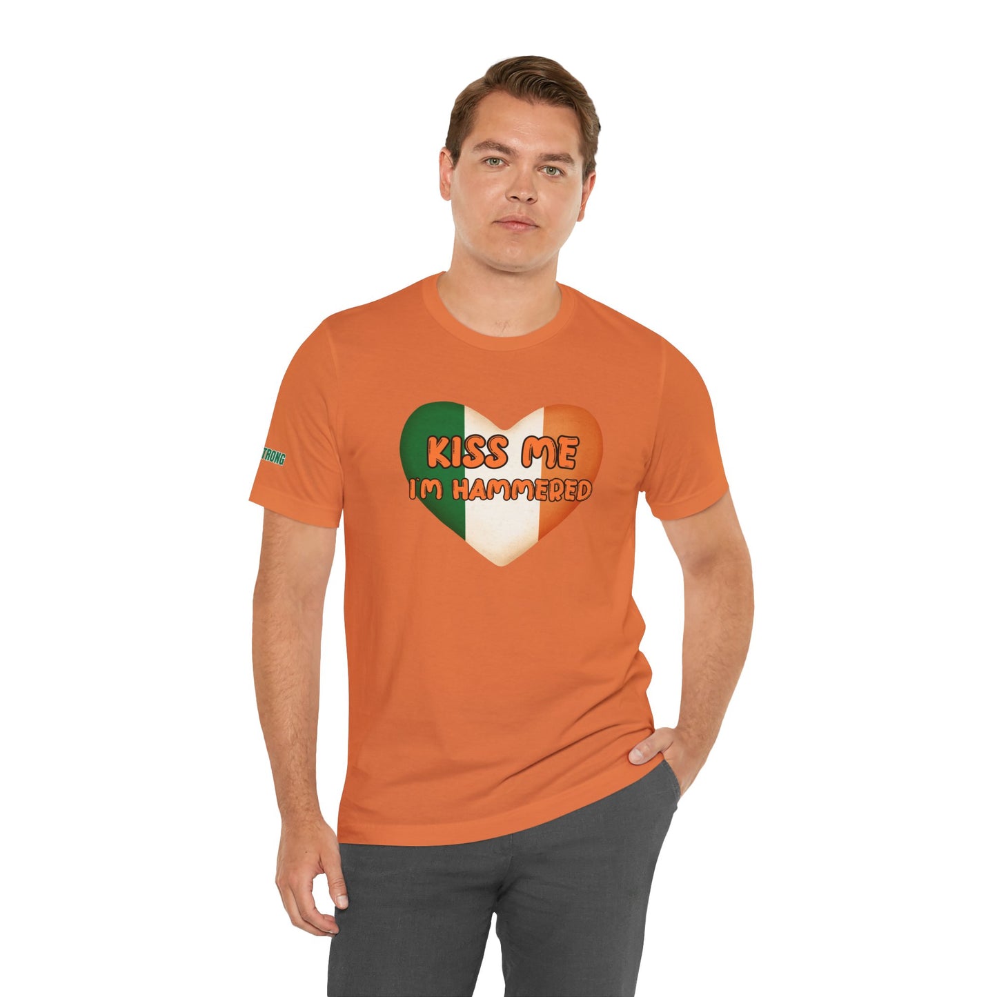 Funny St. Patrick’s Day t-shirt featuring a heart-shaped Irish flag with the phrase “Kiss Me, I’m Hammered” in bold, playful font.