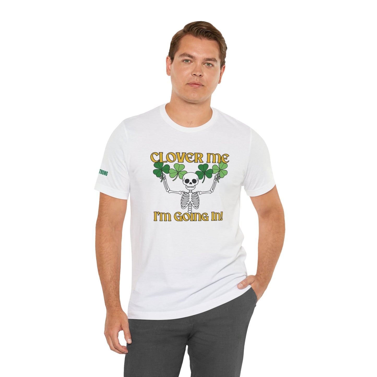 St. Patrick’s Day t-shirt featuring a skeleton with raised arms holding four-leaf clovers, paired with the phrase “Clover Me, I’m Going In!” in bold gold font on a black background.