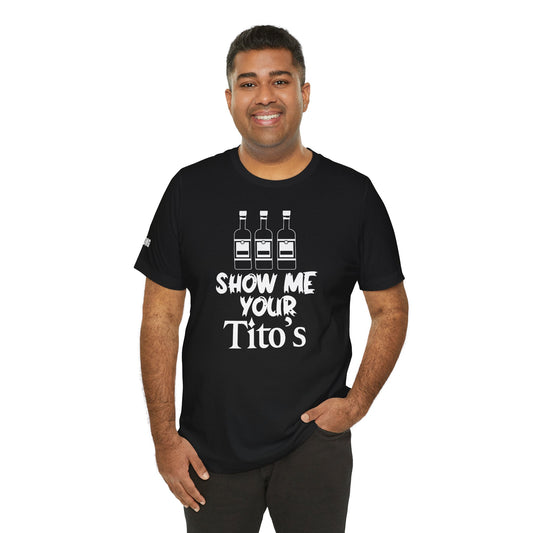Model wearing the "Show Me Your Tito’s" t-shirt, available in multiple colors and plus sizes, perfect for vodka lovers and party-goers.