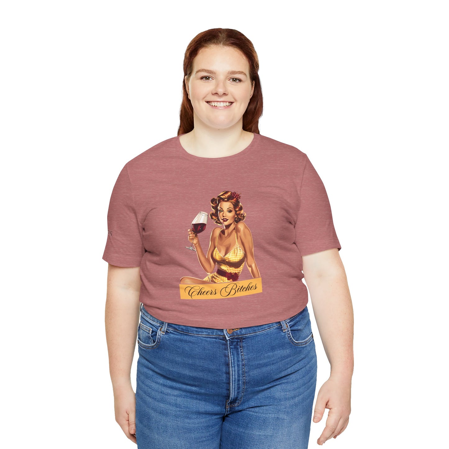 Retro pin-up girl in a yellow gingham dress holding a glass of red wine, with the phrase "Cheers Bitches" in an elegant script banner, in plus sizes.