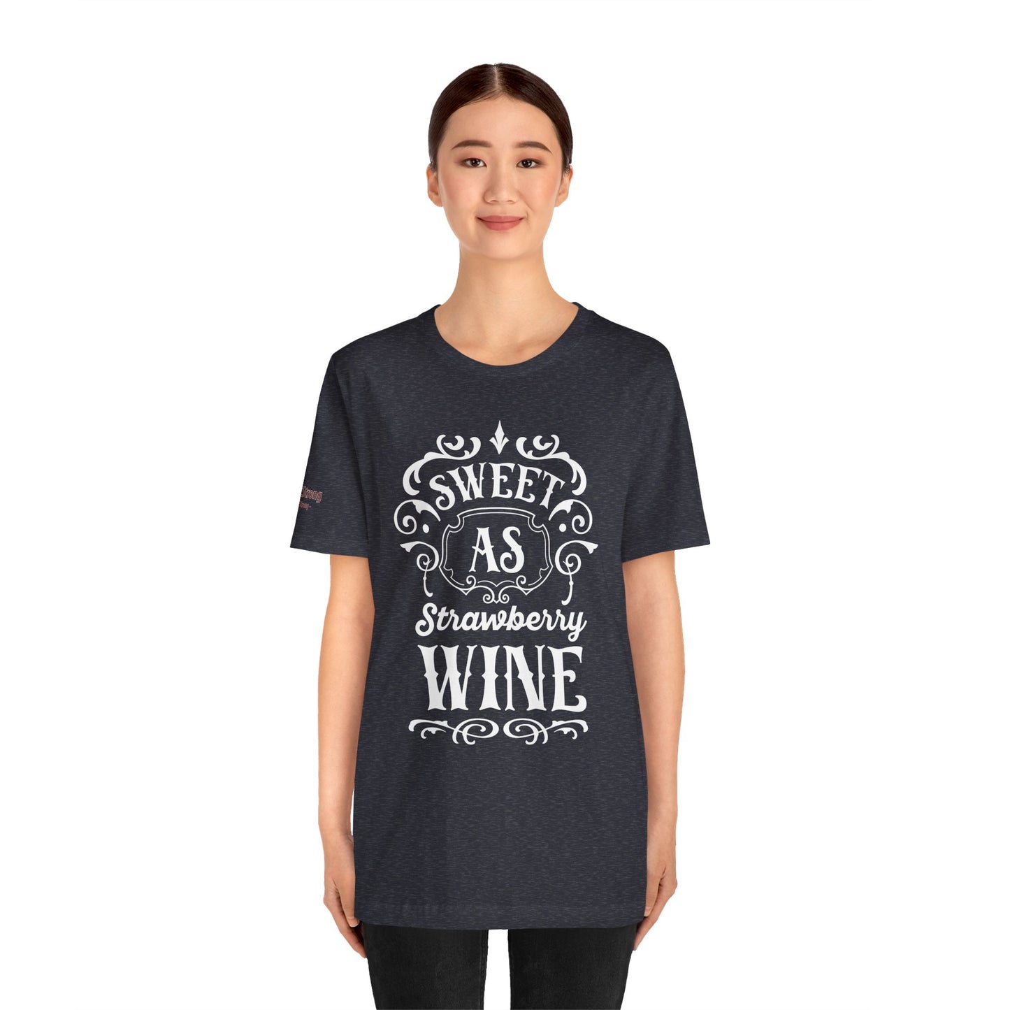 A wine-themed t-shirt design featuring romantic cursive lettering with “Sweet as Strawberry Wine” and subtle vintage-inspired details.