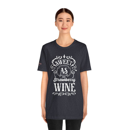 A wine-themed t-shirt design featuring romantic cursive lettering with “Sweet as Strawberry Wine” and subtle vintage-inspired details.