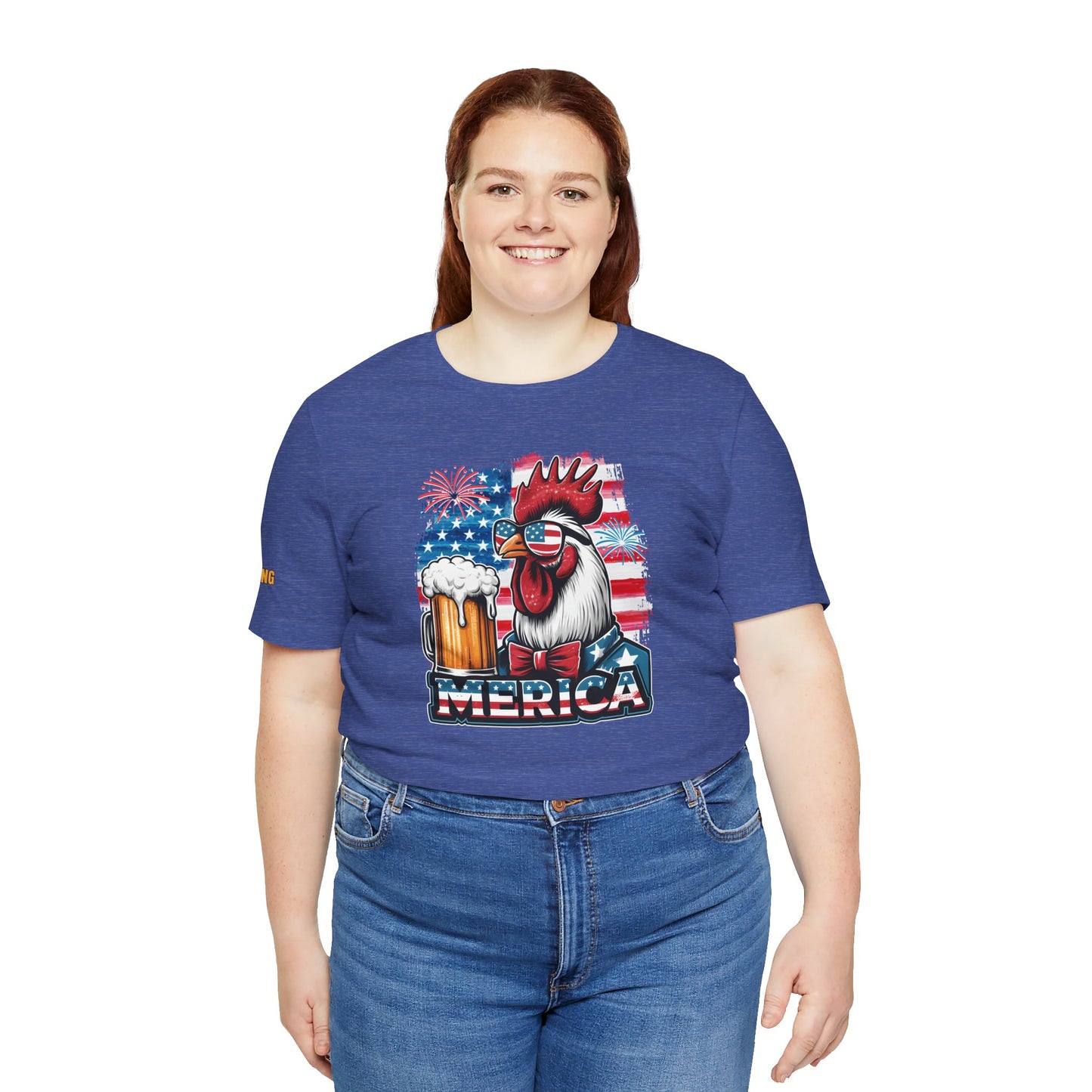 Cool rooster wearing American flag sunglasses and bowtie, holding a beer mug, with fireworks and USA flag in the background. Available in plus sizes.