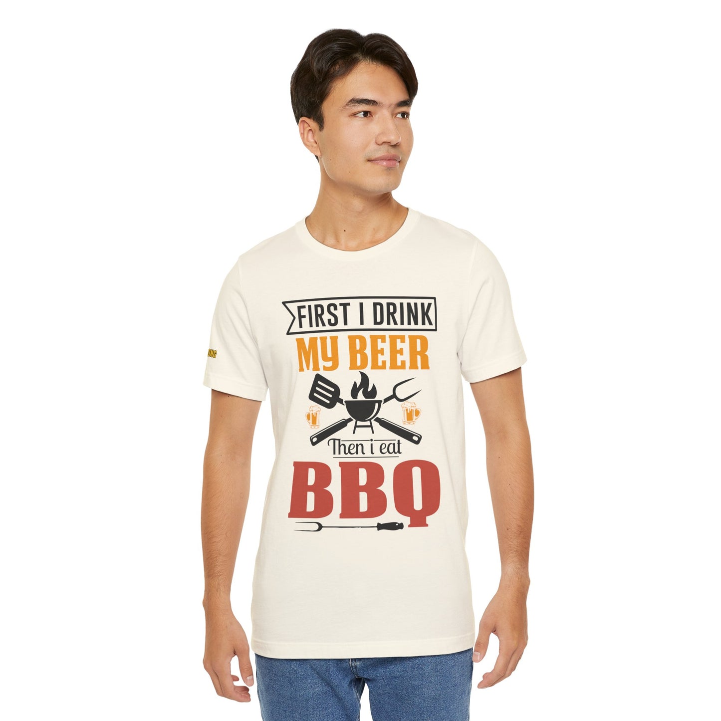 BBQ and beer t-shirt with "First I Drink My Beer, Then I Eat BBQ" text, featuring beer mugs and bold lettering.