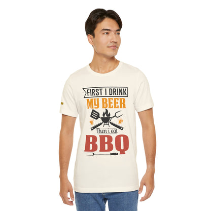 BBQ and beer t-shirt with "First I Drink My Beer, Then I Eat BBQ" text, featuring beer mugs and bold lettering.