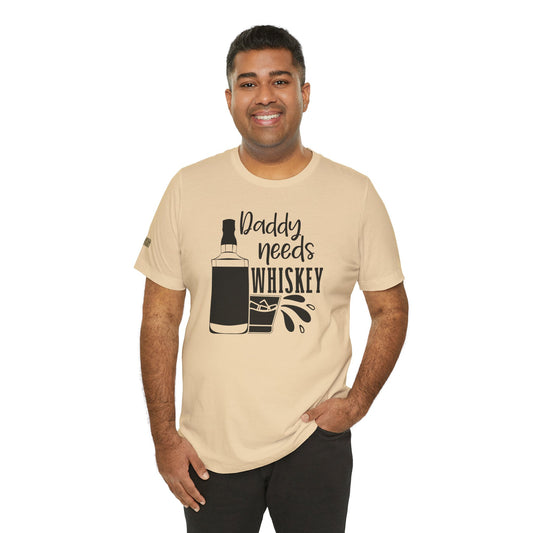 Daddy Needs Whiskey humorous graphic tee with whiskey bottle, glass, and playful drinking quote design. Shown in shade of beige; comes in many colors and plus sizes.