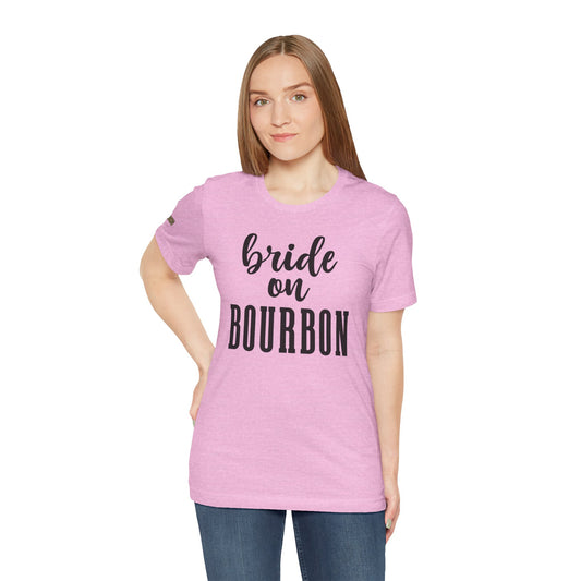 Stylish black on pink text design featuring the phrase "Bride on Bourbon," perfect for whiskey-loving brides and bachelorette celebrations. Available in multiple colors and plus sizes.