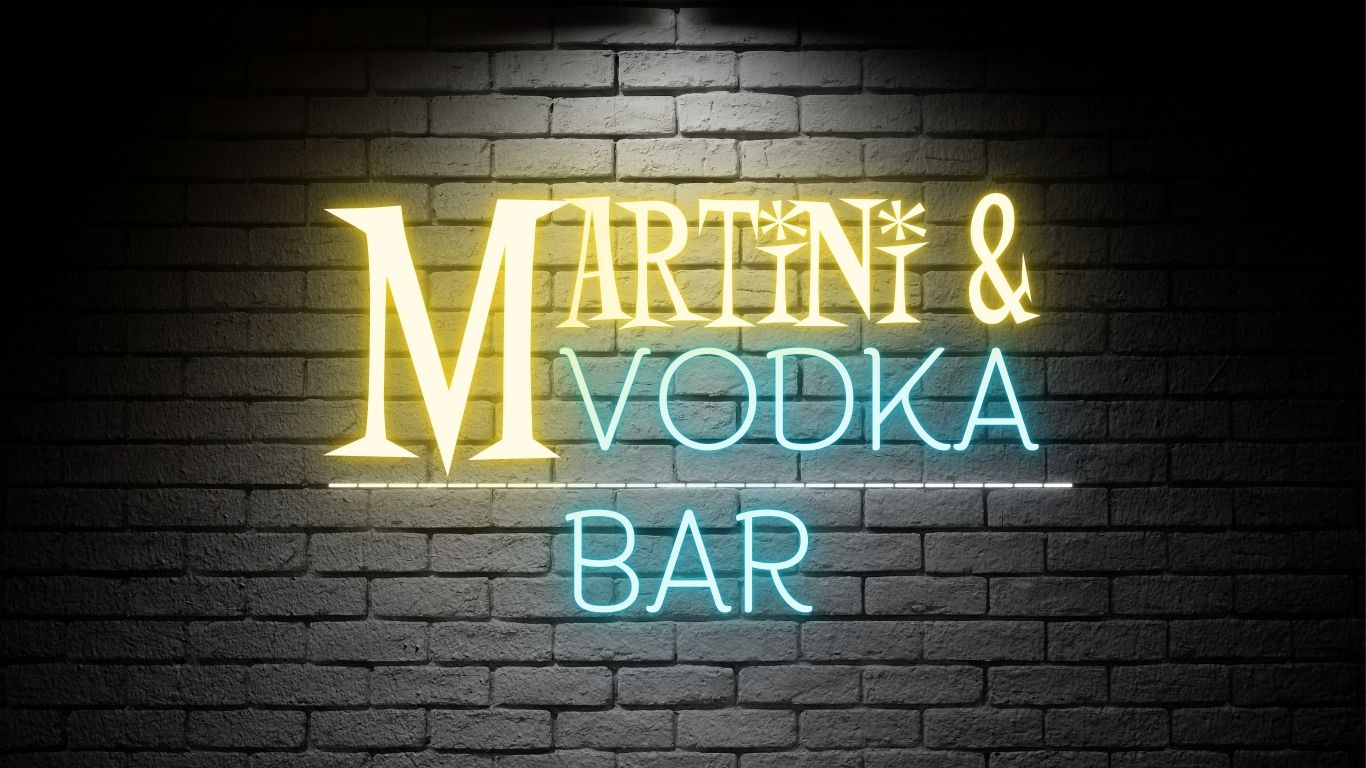 Martini & Vodka Bar neon sign on a dark brick wall background, featuring glowing icy blue and golden yellow text. Perfect for vodka lovers, martini enthusiasts, and cocktail-themed apparel and gifts
