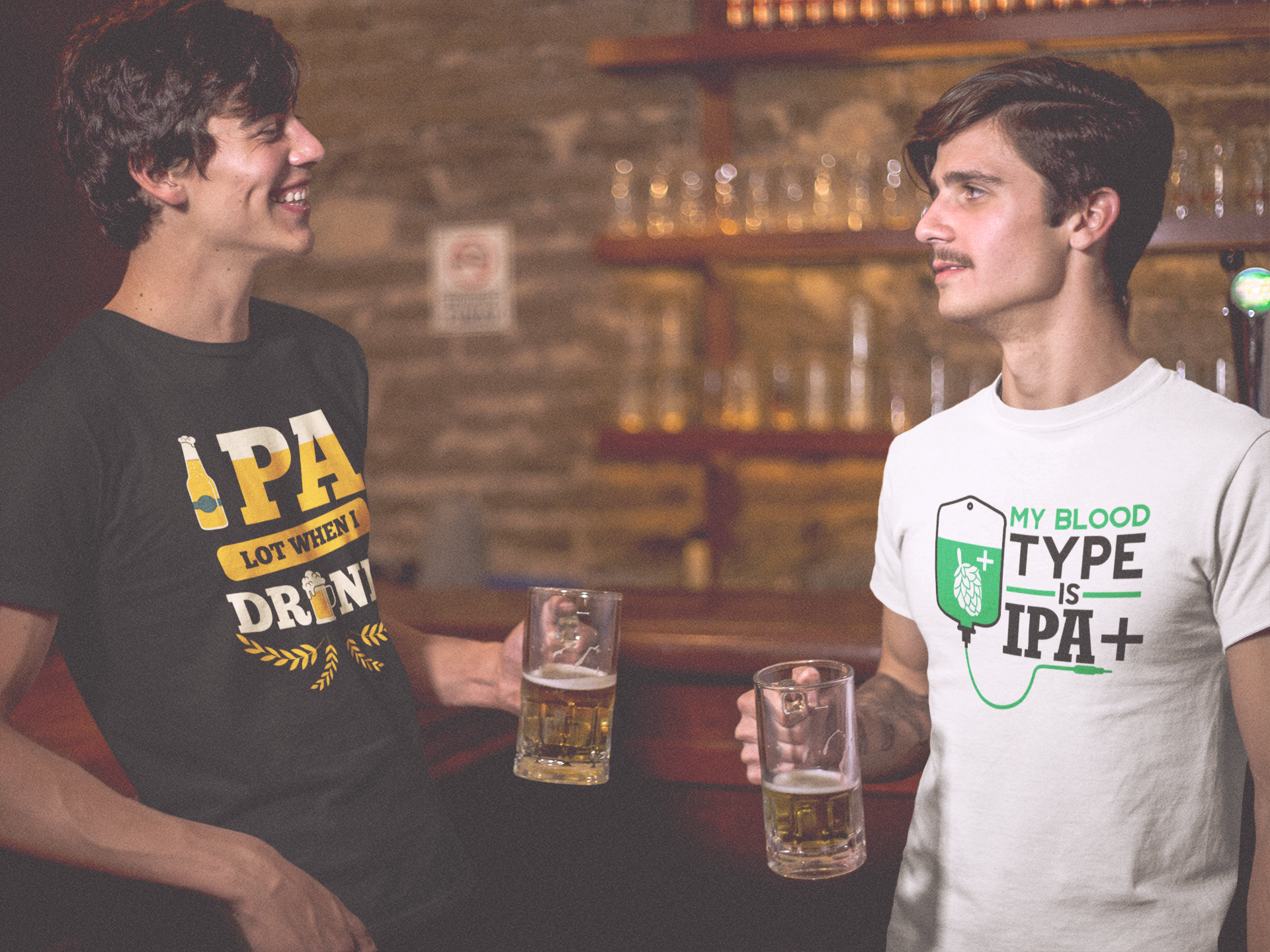 Two craft beer lovers at a bar enjoying pints while rocking IPA-themed t-shirts. One shirt features ‘IPA Lot When I Drink’ with beer bottle graphics, while the other reads ‘My Blood Type is IPA+’ with a hop-infused IV bag. Perfect for IPA enthusiasts, homebrewers, and craft beer fans who take their hops seriously but love a good laugh.